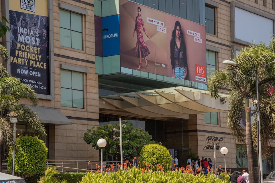 A modern building with large billboards advertising fashion brands.