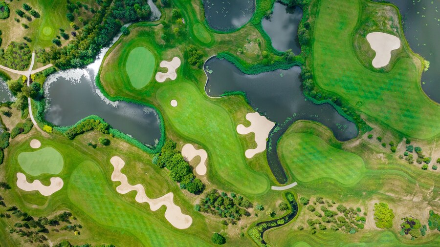 Golf Field Background. Aerial view of green grass and trees on a golf field. Golf course beautiful nature landscape.