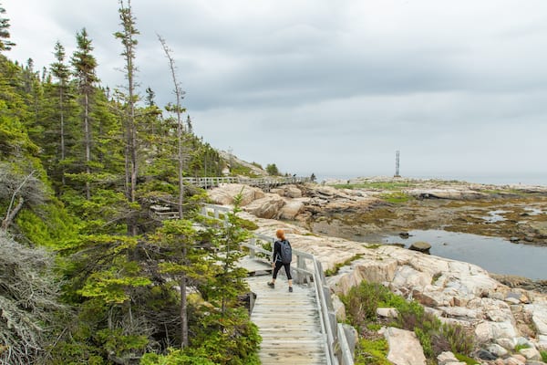 Sentier de la Pointe-de-l\'Islet featuring general coastal views and rocky coastline as well as an individual femail