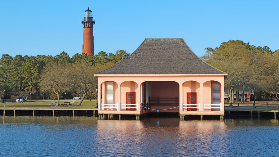 The Currituck Beach Lighthouse and pink boathouse near Corolla, North Carolina