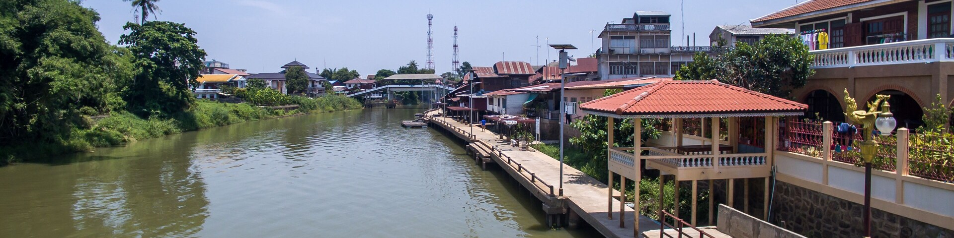 A river with houses and a bridge.