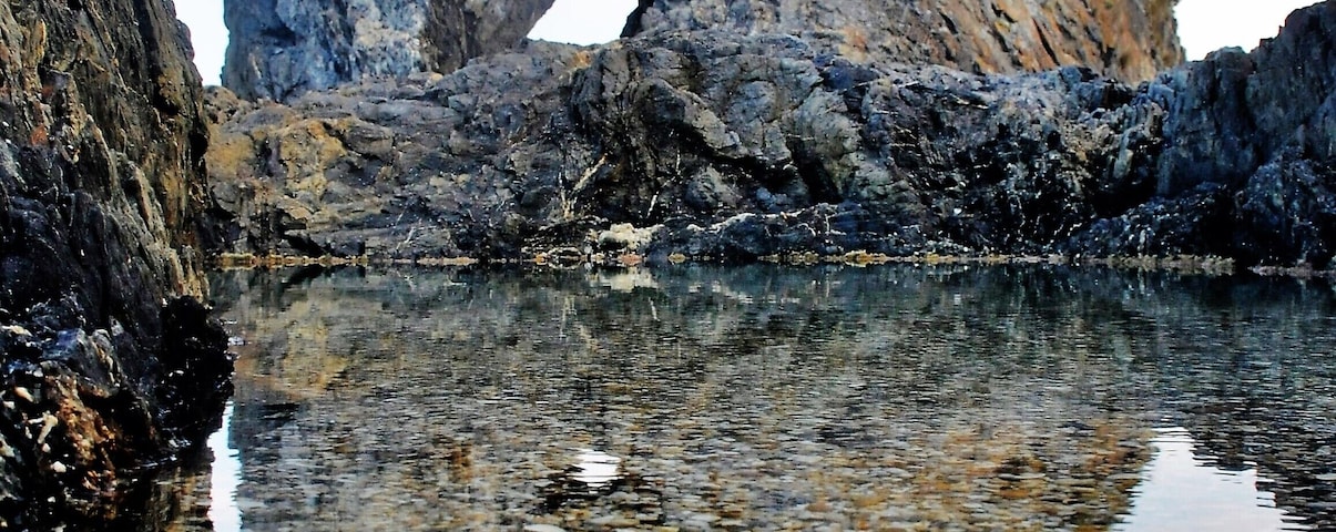 I saw a photograph once, way better than this one, and decided I had to find out where it was.
Well, first up, it's not that easy to get there for a start.  You either have to scramble down a corroding cliff or make your way around at low tide from the south (which is what most people do).  Be prepared to get a little wet.
If the surf's up, forget it; it's way too dangerous, but if you get the right conditions, it's definitely worth a look.