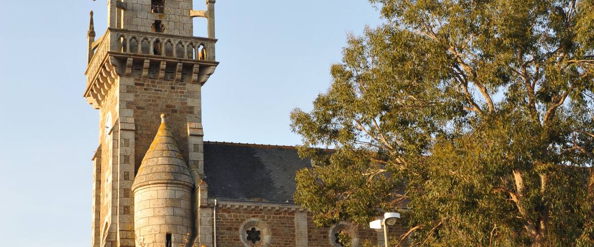 A historic church with a tall spire and a clock tower.