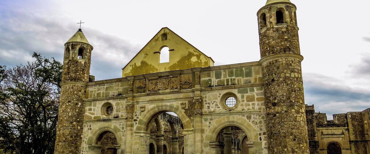 A historic stone church with two bell towers and a central entrance.
