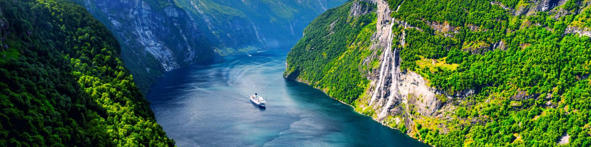 Panorama of breathtaking view of Sunnylvsfjorden fjord and famous Seven Sisters waterfalls, near Geiranger village in western Norway. Landscape photography