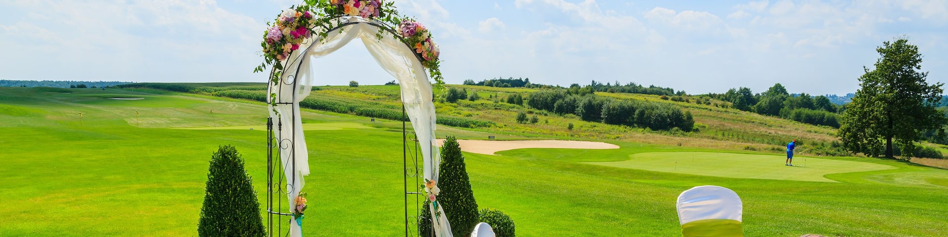 Arch and two white chairs prepared for weeding ceremony, Poland