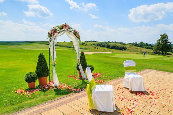 Arch and two white chairs prepared for weeding ceremony, Poland