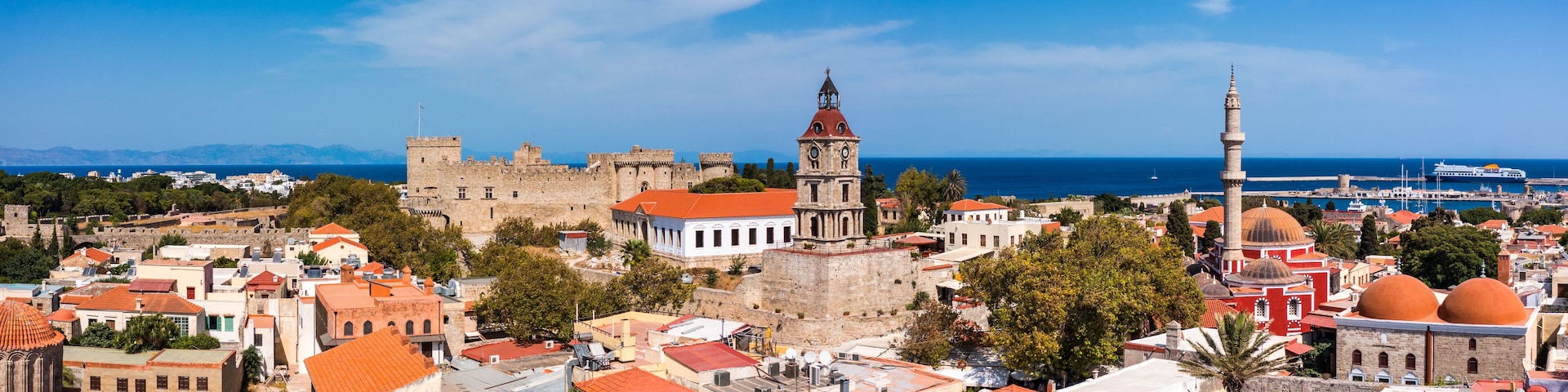 Panoramic view of Rhodes old town on Rhodes island, Greece. Rhodes old fortress cityscape with sea port at foreground. Travel destinations in Rhodes, Greece.