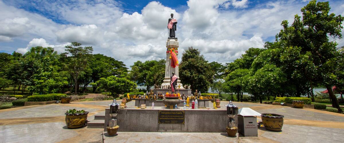 A statue in a park with a clear sky.