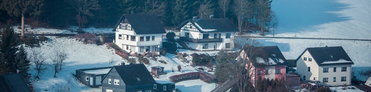 Houses in snowy mountain valley. Niedersfeld, Germany.