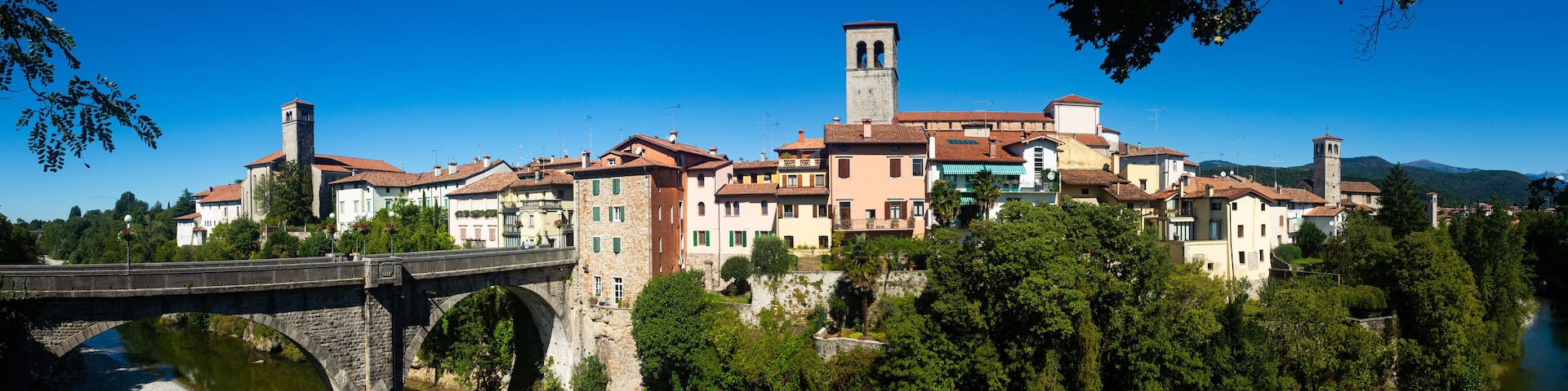 View of historic centre of Cividale del Friuli with medieval stone Devil Bridge (Ponte del Diavolo) over Natisone river, Italy