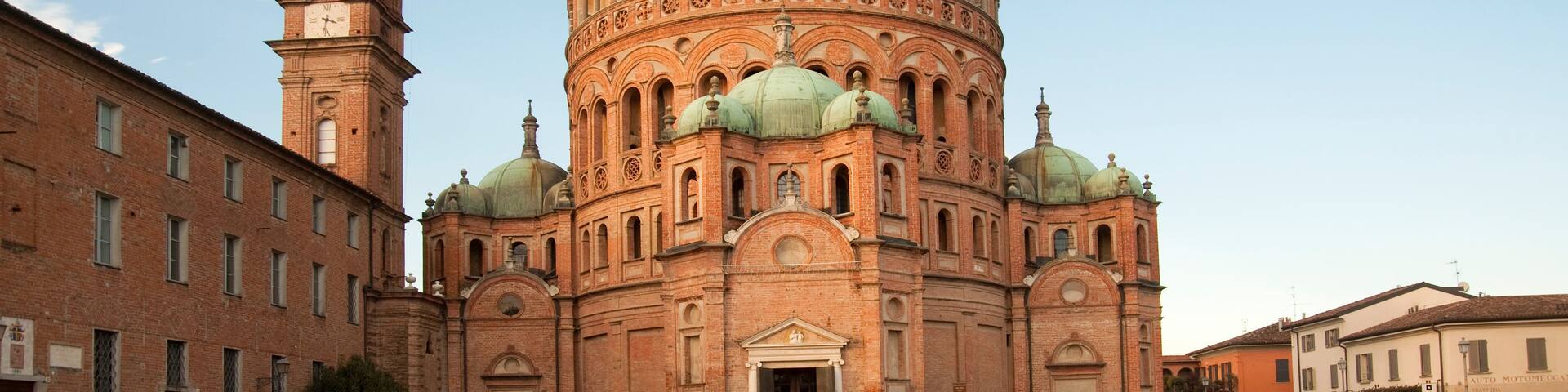 A historic church with a prominent bell tower and a large dome.