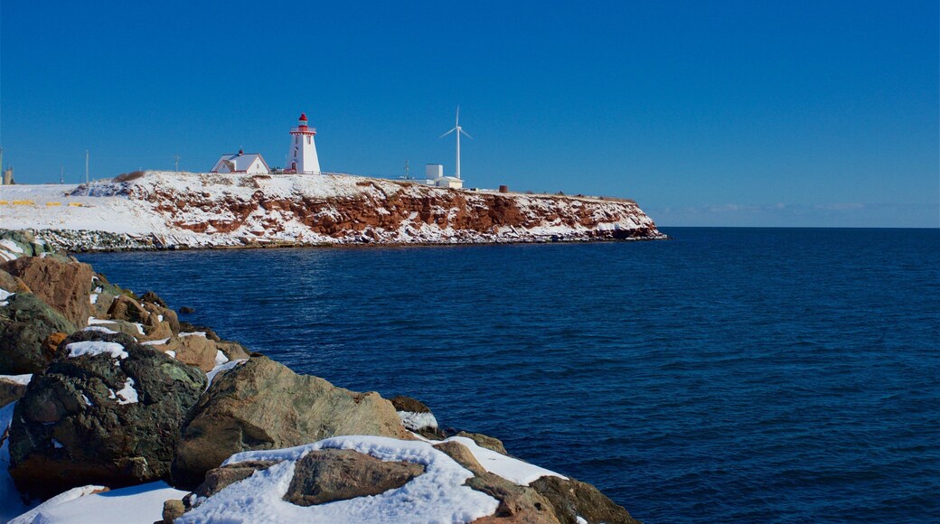 Souris Lighthouse which includes snow and a sandy beach