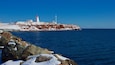 Souris Lighthouse which includes snow and a sandy beach
