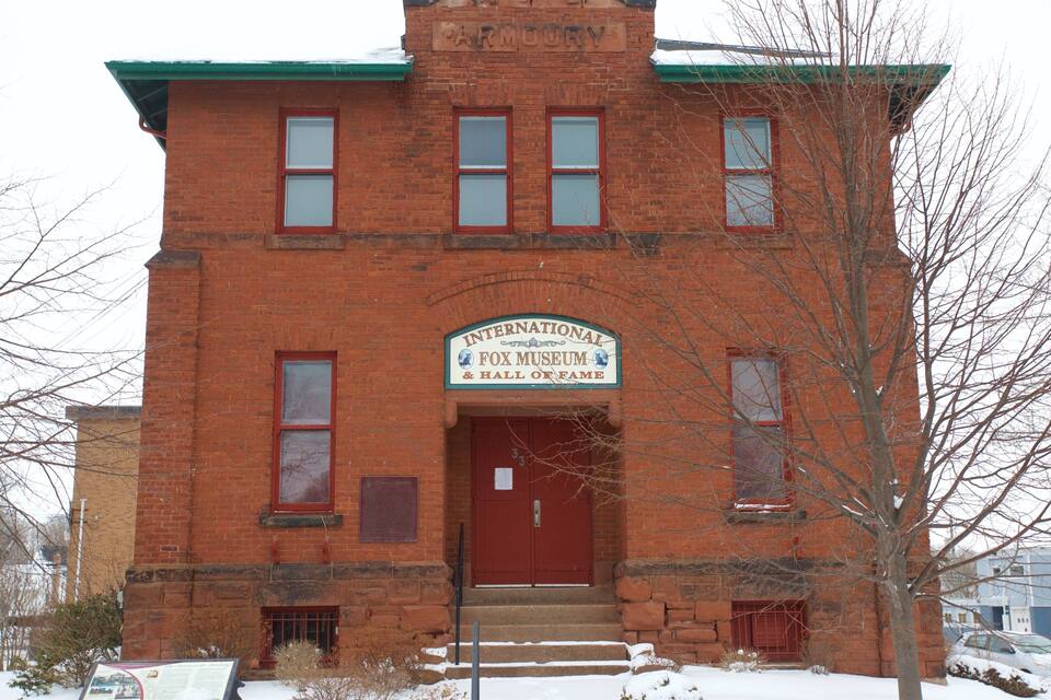 A red brick building with a sign reading "International Fox Museum & Hall of Fame".