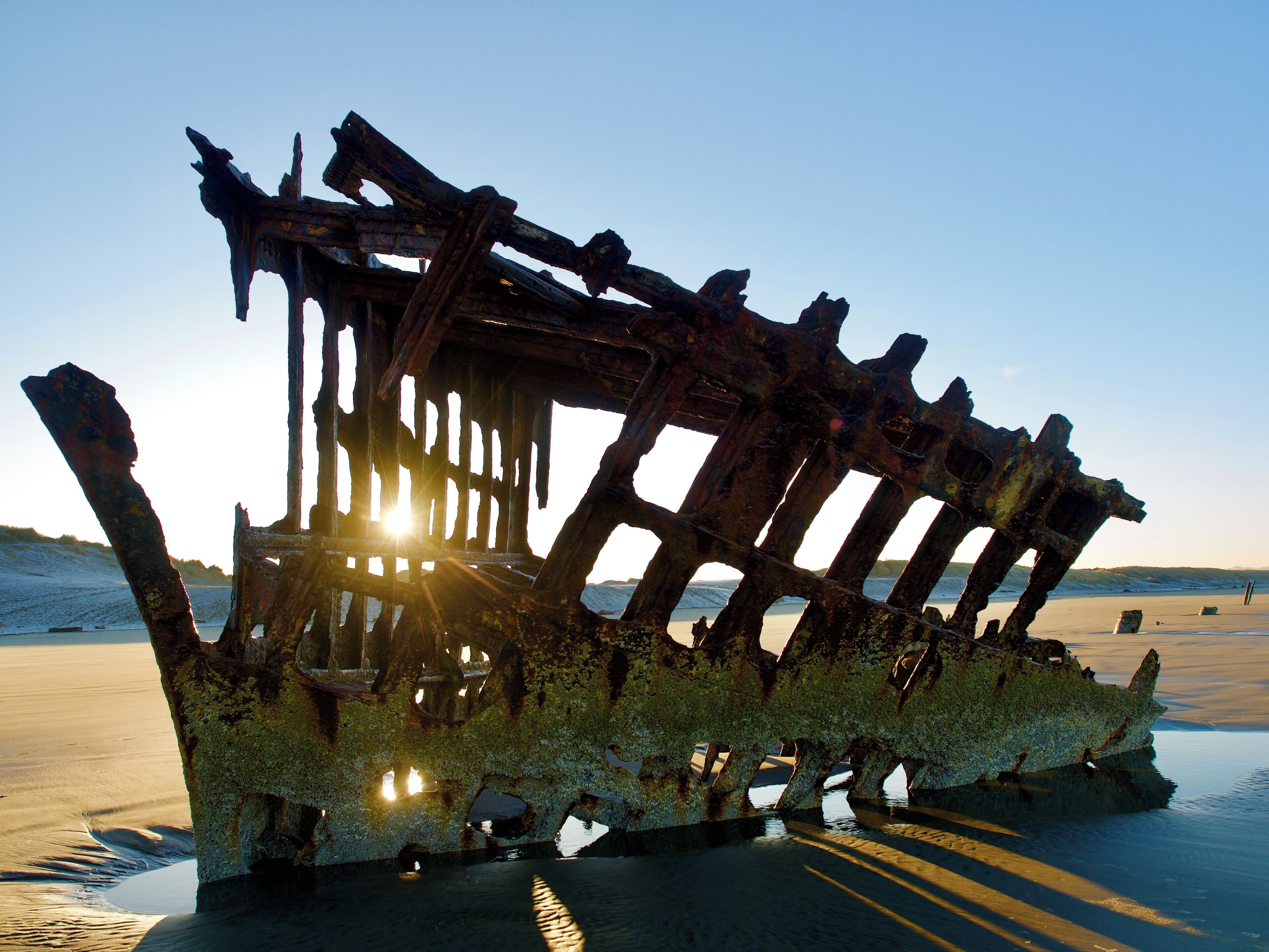 This is an oft-photographed landmark on the Oregon coast. Located on the Beach at the western edge of Fort Stevens State Park near Hammond, Oregon. It’s a short drive west from Astoria, Oregon and makes for a fantastic photo op. Most of the shots online seem to be afternoon through sunset. I was only able to shoot here at sunrise but I was blown away by the opportunity that presented itself. Sunrise can make for a beautiful shot too! Very cold this morning too. Temps right at freezing. There was frost on some of the sand.