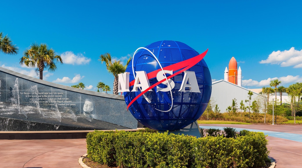 PARA28 NASA Logo on Globe at Kennedy Space Center Visitor Complex in Cape Canaveral, Florida, USA. To the left is a painting visible of John F. Kennedy.
