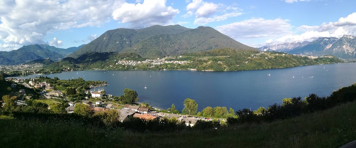 A lake surrounded by mountains and a town.