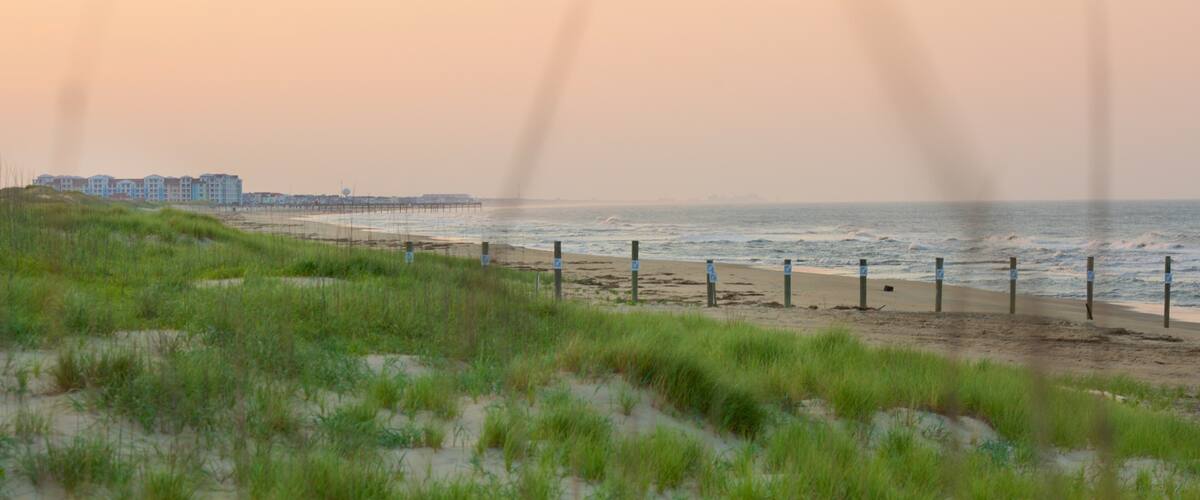 False Cape State Park featuring a beach, a sunset and landscape views