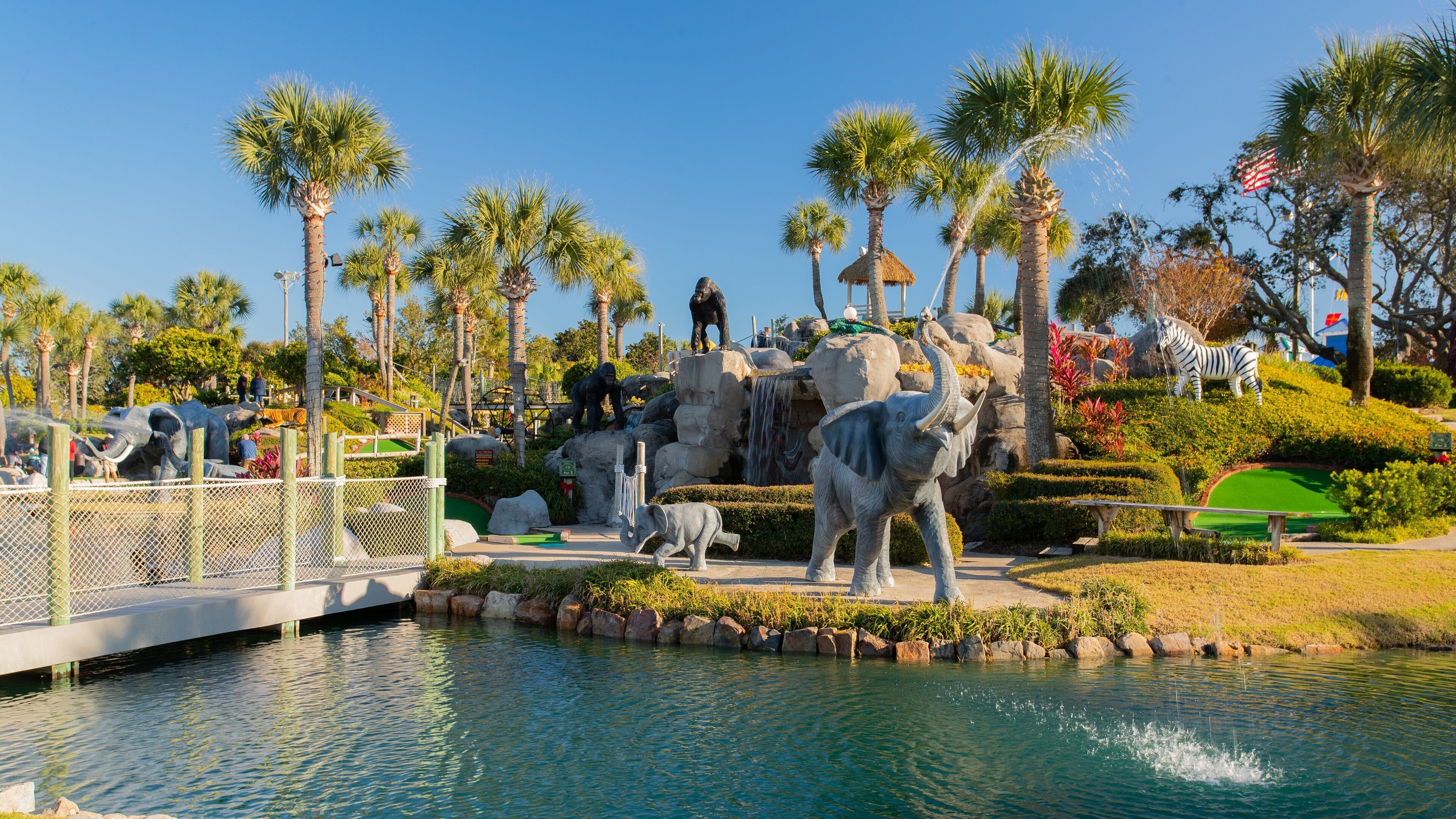 Coconut Creek Family Fun Park featuring a fountain, a garden and outdoor art