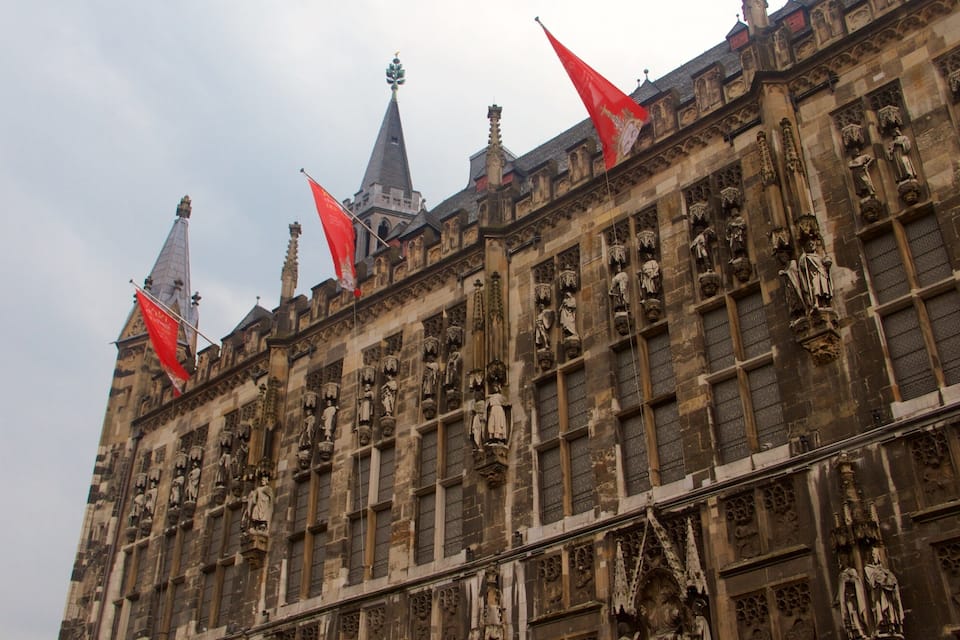 A historic building with intricate stone carvings and multiple spires.