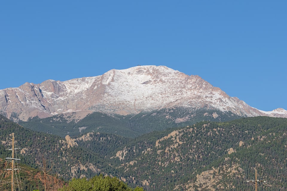 A snow-capped mountain with a clear blue sky.
