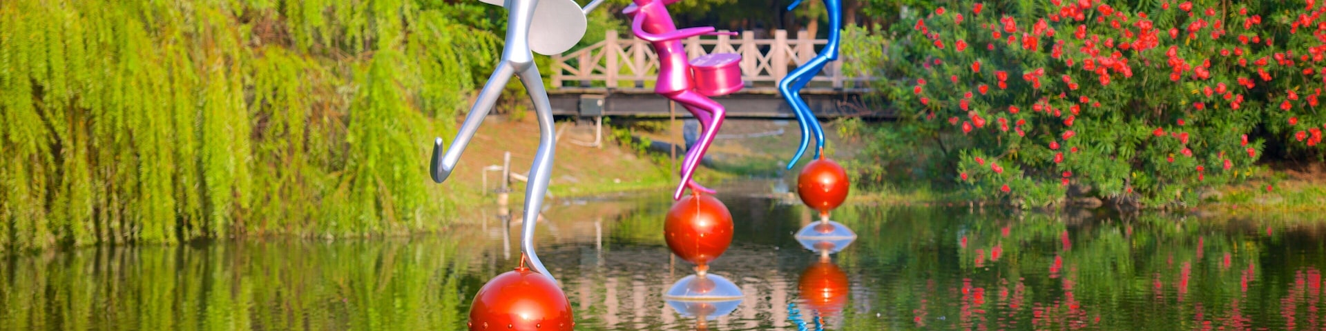 Central Park featuring a lake or waterhole, outdoor art and a park