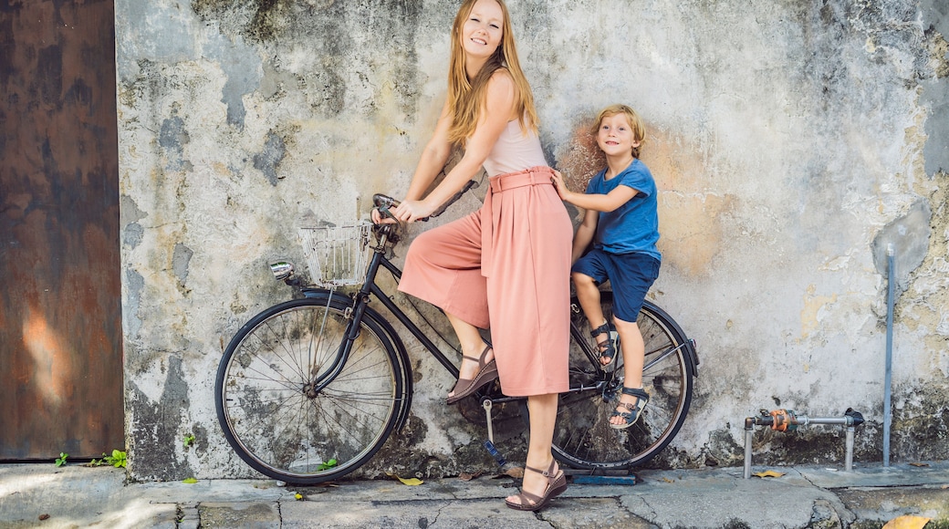 Mother and son on a bicycle. Public street art Name Children on a bicycle painted 3D on the wall that's two little Chinese girls riding bicycle in Georgetown