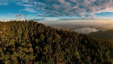 Aerial view of Bukit Mertajam Hills and Mengkuang Dam during sunrise. Located at Bukit Mertajam, Penang.