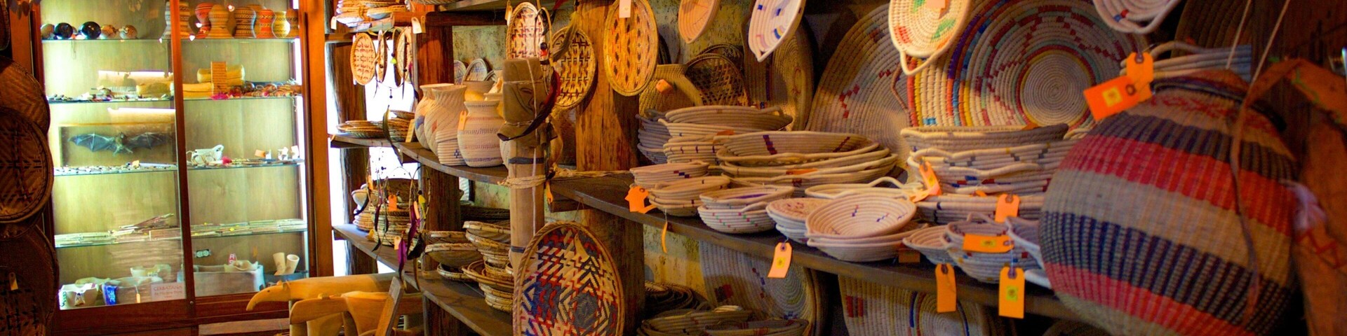 A store with shelves full of woven baskets and pottery.