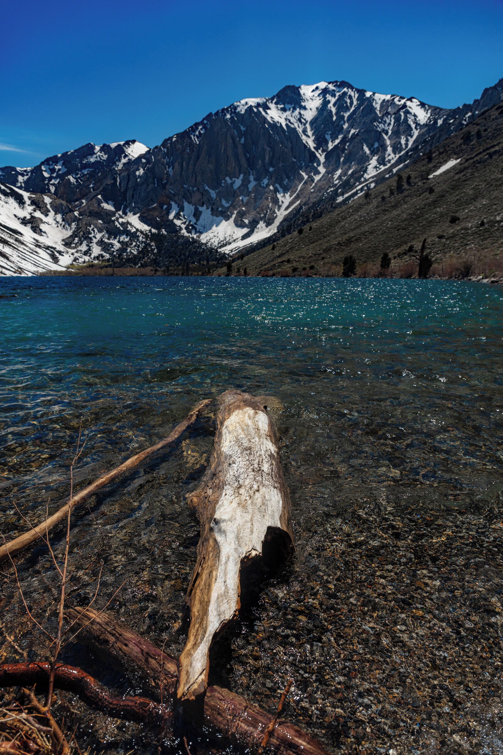 So you have to come here! This lake was absolutely beautiful! Perfect background, crystal blue water, and a path all the way around. I really wish I stayed here for the night, but the campground was full and it was only noon. 
You can rent boats, canoes, there is a really nice campground, and I am absolutely sure it has great sunrise/sets. If I ever get around to this area again, I will be sure to stay here a night or two.
