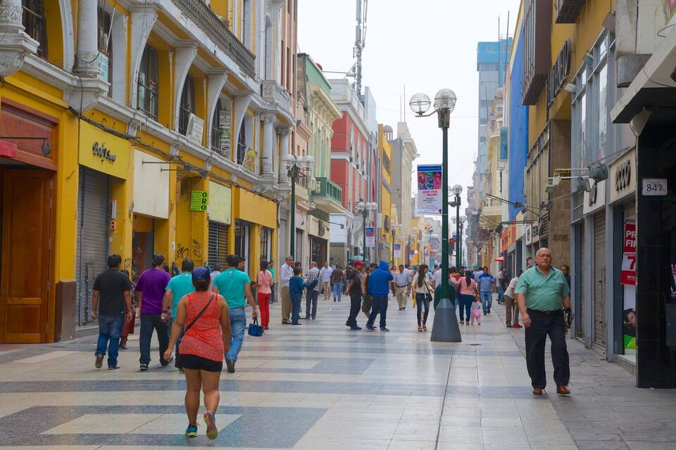 A busy pedestrian street lined with colorful buildings and shops.