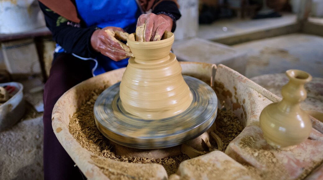 Closeup of Local woman demonstrates on making traditional clay jar called "Labu Sayong" or Essence Jar of Sayong in Kuala Kangsar, Perak, Malaysia.