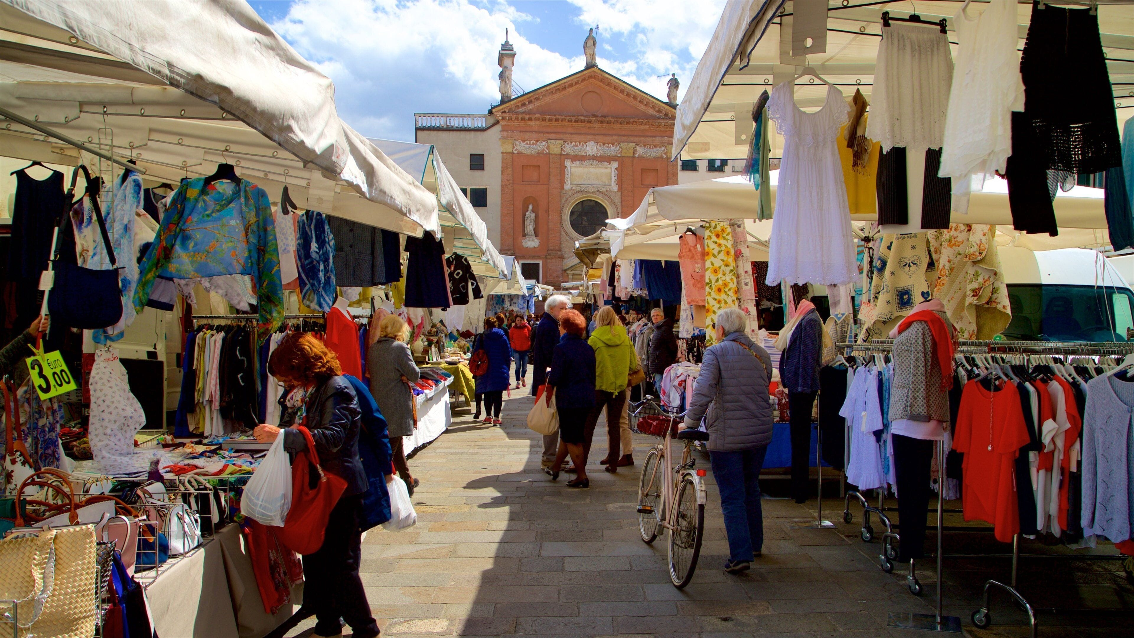 Piazza dei Signori featuring markets and street scenes as well as a small group of people