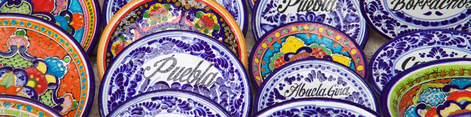A collection of colorful ceramic plates with intricate designs and text.