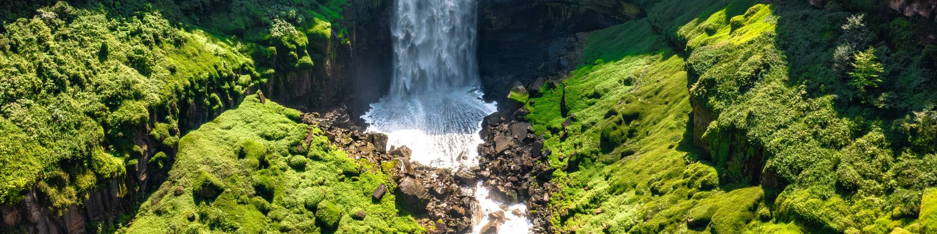 Panoramic view of Tequendama Falls waterfall plunging into vast green canyon near Bogota Colombia landscape
