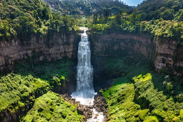 Panoramic view of Tequendama Falls waterfall plunging into vast green canyon near Bogota Colombia landscape