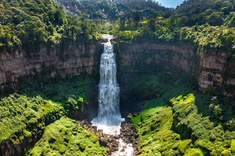 Panoramic view of Tequendama Falls waterfall plunging into vast green canyon near Bogota Colombia landscape