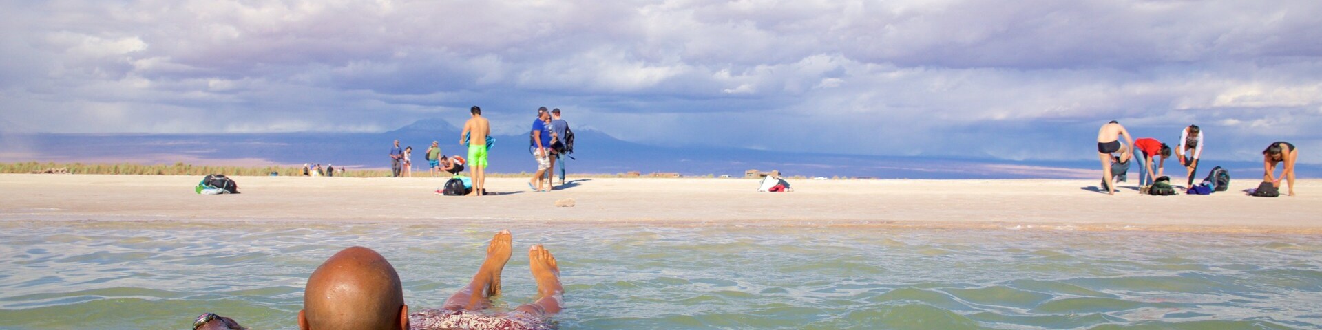 Cejar Lagoon featuring swimming and a sandy beach as well as an individual male