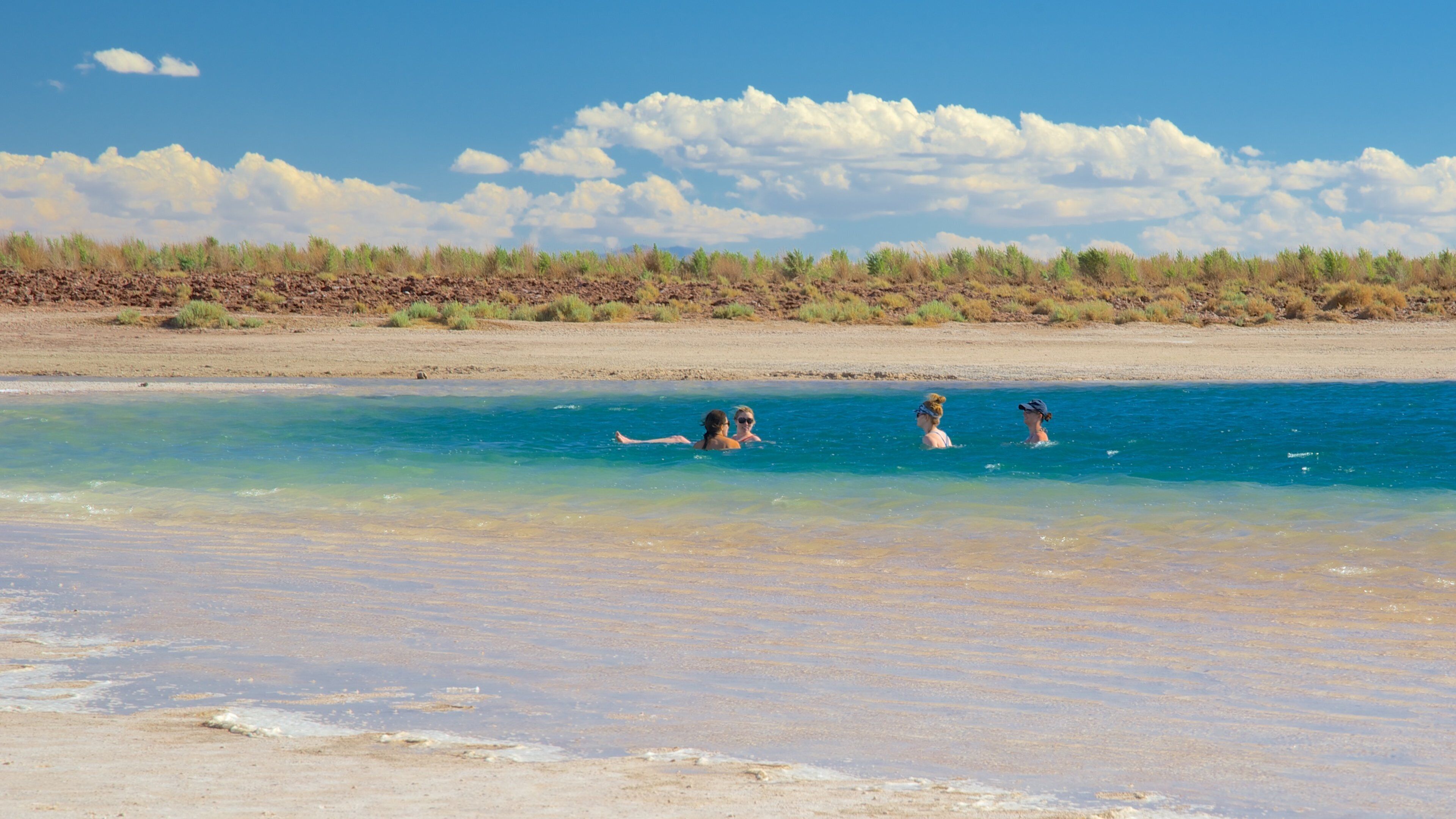 Cejar Lagoon featuring tranquil scenes and a lake or waterhole as well as a small group of people