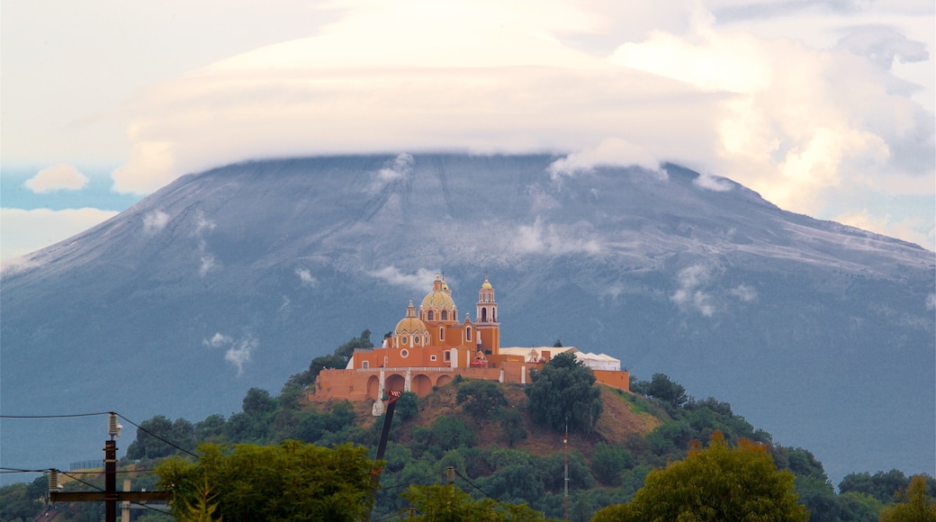 La Virgen de los Remedios Sanctuary showing mist or fog, heritage elements and mountains