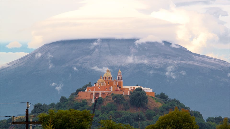 La Virgen de los Remedios Sanctuary featuring mountains, heritage elements and mist or fog