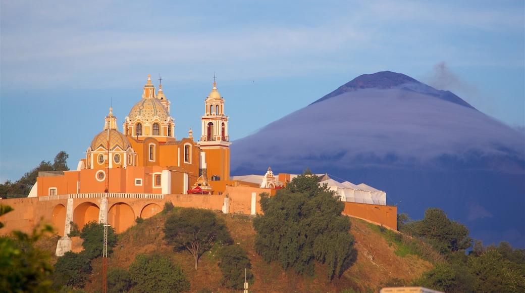 La Virgen de los Remedios Sanctuary showing mountains, heritage elements and a sunset