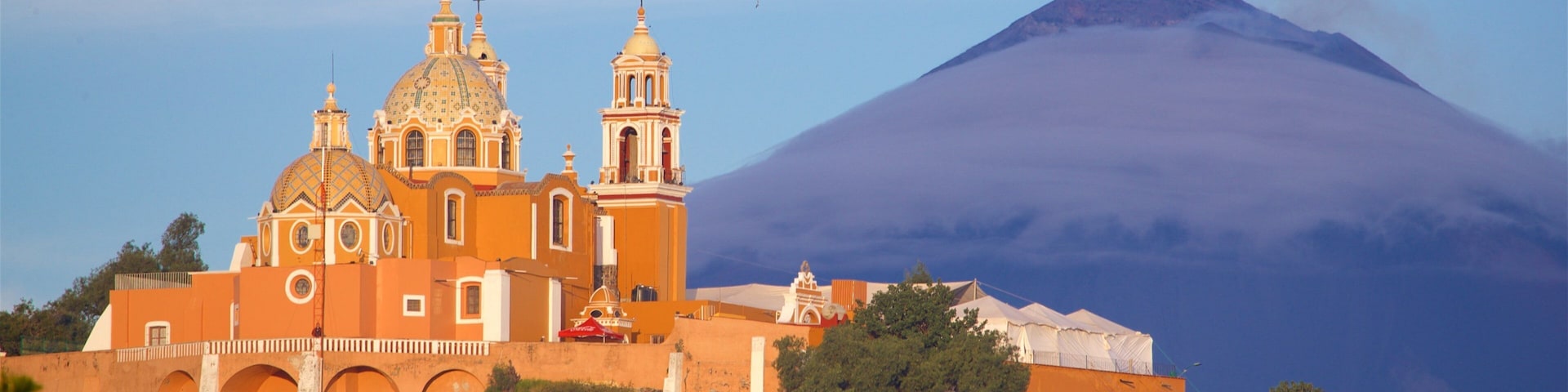 La Virgen de los Remedios Sanctuary showing mountains, heritage elements and a sunset