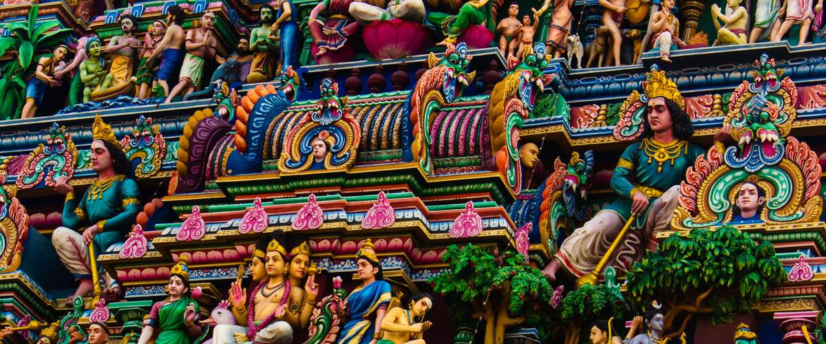 A colorful temple with intricate carvings and statues.