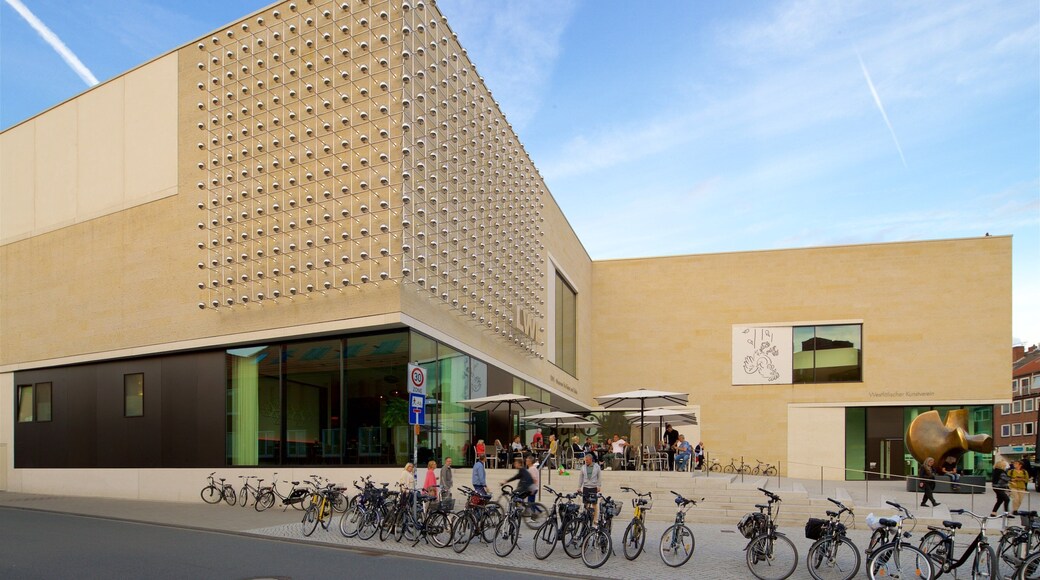 Westphalian State Museum for Art and Cultural History featuring outdoor eating and modern architecture as well as a small group of people