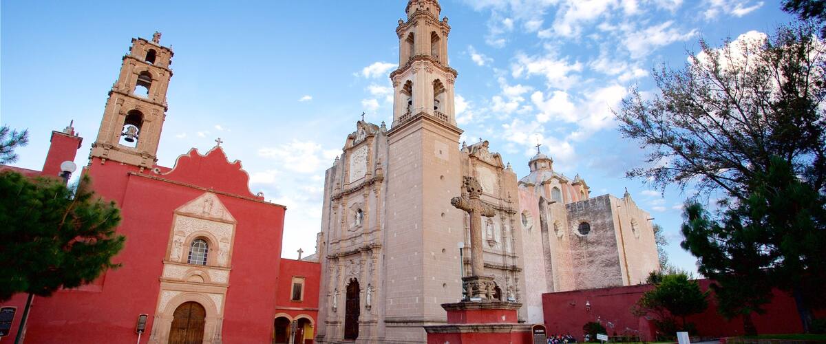 A historic church with a bell tower and a large central tower.