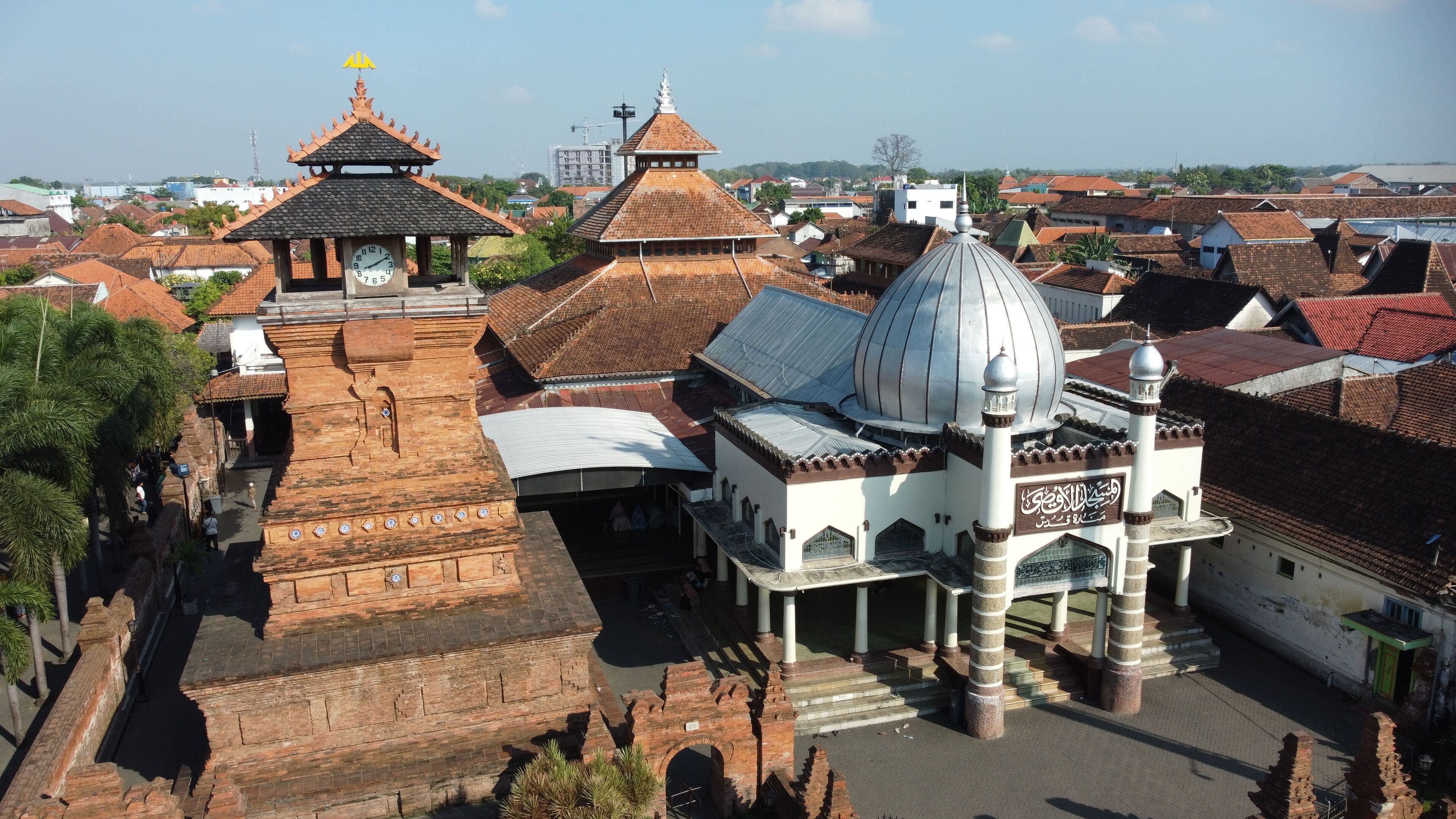 An ancient temple complex with a large central dome and smaller structures with traditional roofs.