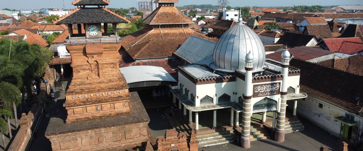An ancient temple complex with a large central dome and smaller structures with traditional roofs.