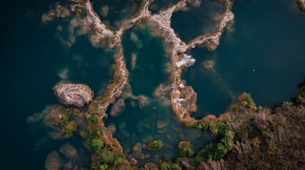 Aerial view of the cascading waters of Tamasopo River, where the river carves through the landscape creating a mesmerizing mosaic of turquoise pools, San Luis Potosi, San Luis Potosi, Mexico.